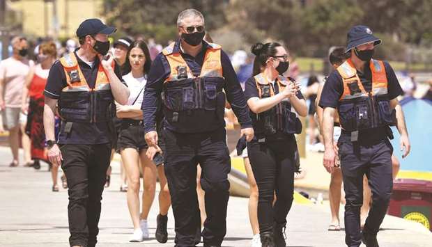 Officers patrol while people enjoy the warm weather on Melbourneu2019s St Kilda Beach yesterday.