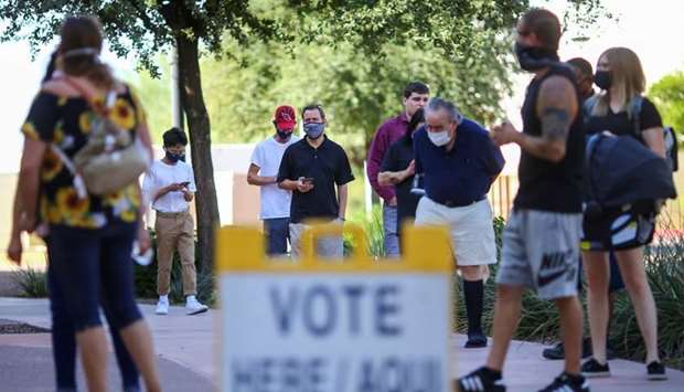 People line up to cast their vote at a polling station on Election Day in Surprise, Arizona