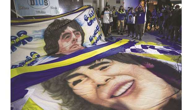 Supporters of Argentine former football star Diego Maradona gather outside the hospital where he underwent brain surgery for a blood clot, in Olivos, Buenos Aires province.