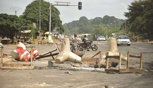 Debris of a road blockade is seen in a street caused by demonstrators during the post-election violence in Yamoussoukro yesterday.