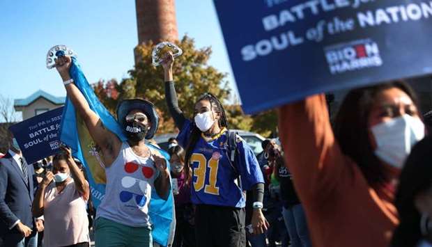 People celebrate the news that Democratic presidential nominee Joe Biden has seemingly won the election while waiting at the Chase Center where Mr. Biden is expected to make an announcemen in Wilmington, Delaware