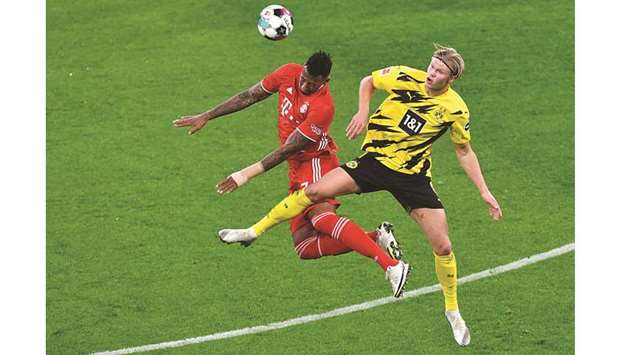 Bayern Munichu2019s Jerome Boateng (left) and Dortmundu2019s Erling Braut Haaland go for a header during the Bundesliga match in Dortmund, western Germany, yesterday. (AFP)