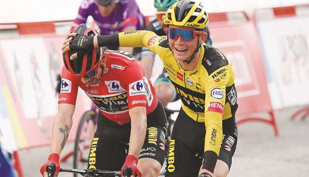Team Jumbou2019s Slovenian rider Primoz Roglic (L) is congratulated by a rival for  winning the 2020 La Vuelta at the end of the 18th and final stage in Madrid yesterday.