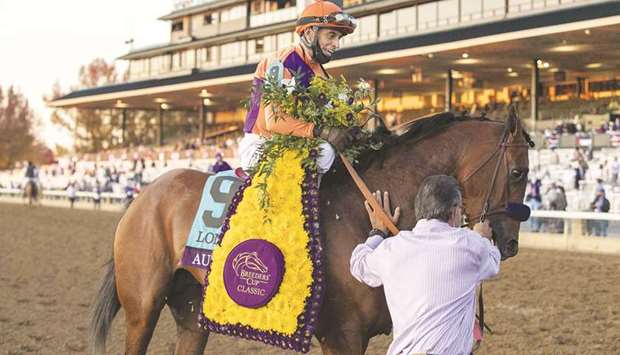 Jockey John Velazquez walks Authentic to the winners circle after winning the Breedersu2019 Cup Classic at Keenland in Lexington, Kentucky, yesterday. (Getty Images/AFP)