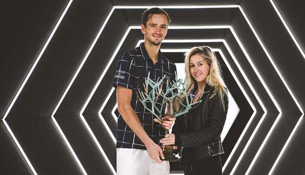 Russiau2019s Daniil Medvedev (L) poses with the trophy and his wife Daria Medvedeva (R), after beating Germanyu2019s Alexander Zverev to win the Paris Masters yesterday.