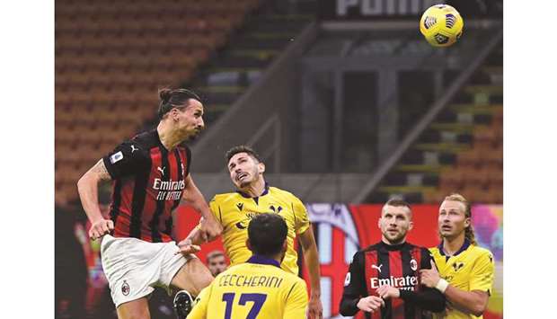 Ac Milan forward Zlatan Ibrahimovic (left) scores during the Italian Serie A match against Hellas Verona at the San Siro stadium in Milan on Sunday night. (AFP)