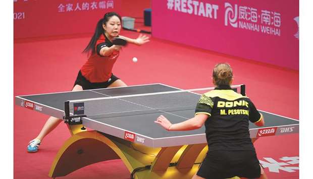 This photo taken on November 8, 2020, shows Lily Zhang (in red) of the US competing with Margaryta Pesotska of Ukraine at the ITTF Womenu2019s World Cup table tennis competition in Weihai, China. (AFP)
