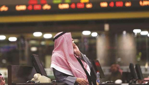 A Kuwaiti trader follows stock prices at Boursa Kuwait stock market in Kuwait City (file). MSCI is due to unveil its semi-annual index review on Tuesday, disclosing Kuwaiti shares to be added to the MSCI Emerging Markets Index that is widely followed by fund managers.
