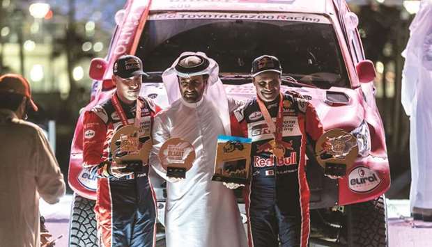 FIA Vice President for Sport Mohamed Ben Sulayem (centre) with Nasser al-Attiyah and Mathieu Baumel at the podium ceremony.