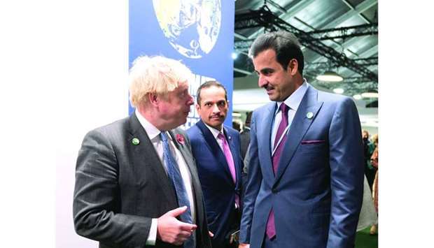 His Highness the Amir Sheikh Tamim bin Hamad al-Thani speaks with UK Prime Minister Boris Johnson on the sidelines of COP26 Monday in Glasgow, as Qatar's Deputy Prime Minister and Minister of Foreign Affairs HE Sheikh Mohamed bin Abdulrahman al-Thani looks on