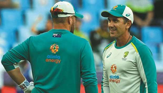 Australiau2019s captain Aaron Finch (left) listens to his teamu2019s coach Justin Langer before the start of the ICC Twenty20 World Cup semi-final against Pakistan in Dubai on Thursday. (AFP)