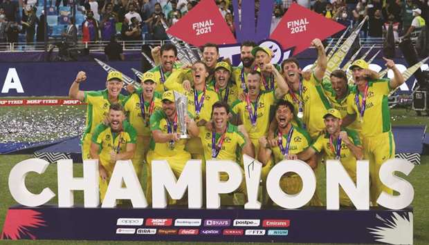 Australia captain Aaron Finch celebrates with the trophy and teammates after winning the ICC T20 World Cup in Dubai yesterday. (Reuters)