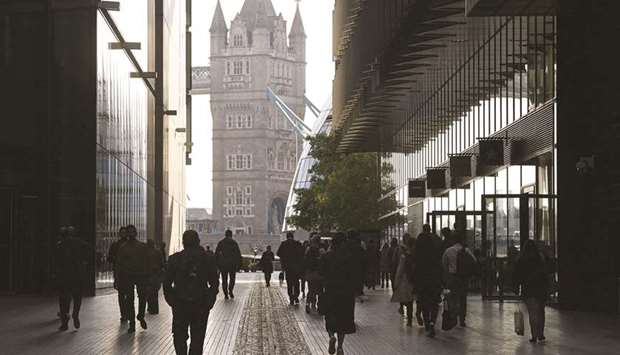 Workers walk towards Tower Bridge in London. The Bank of England has been watching closely in case unemployment rose after the job-protecting furlough scheme expired at the end of September.