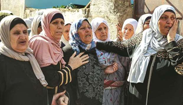 Relatives of Palestinian Saddam Bani Odeh, who was killed earlier amidst dawn clashes with Israeli troops, react during his funeral in the village of Tammun near Nablus in the occupied West Bank, yesterday.