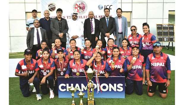 Nepal womenu2019s team players pose with the trophy and QCA officials after winning the T20I series against Qatar at the Asian Town Stadium on Thursday.