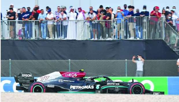 Mercedes' Valtteri Bottas in action as fans watch from the stands during a practice session for the Formula One Ooredoo Qatar Grand Prix at the Losail International Circuit Friday. PICTURES: Noushad Thekkayil