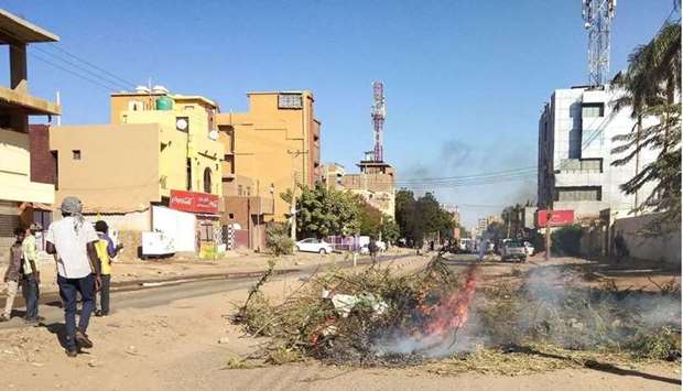 Sudanese youths burn tree branches as they part in an anti-coup protest in the capital Khartoum's Bahri neighbourhood, on November 18. AFP