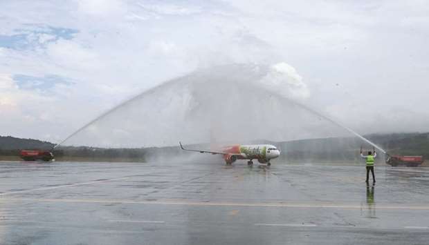 A Vietjet aircraft carrying South Korean tourists passes a water cannon salute at Phu Quoc International airport, in Phu Quoc, Vietnam, yesterday.