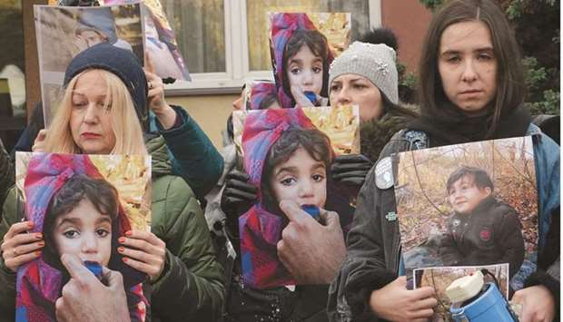 People protest with photos of children to draw attention to the humanitarian situation on the Polish-Belarusian border in Hajnowka near the border between the two countries yesterday. (AFP)