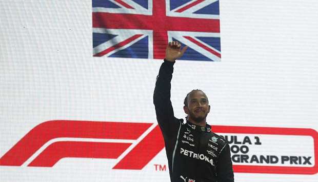 Mercedes' Lewis Hamilton celebrates on the podium after winning the race.