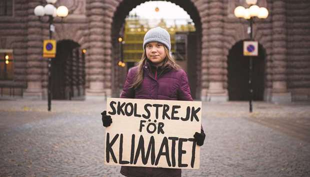 MAKING A STATEMENT: Swedish climate activist Greta Thunberg holding a sign reading u201cSchool strike for Climateu201d as she protests in front of the Swedish Parliament (Riksdagen) in Stockholm last week. (AFP)