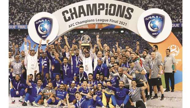 Al Hilal players and staff celebrate with the trophy after winning the Asian Champions League title at the King Fahd International Stadium in Riyadh yesterday. (Reuters)