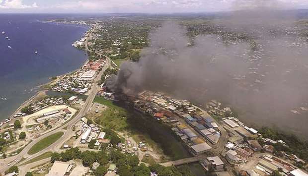 Smoke from burning buildings rise from Honiara on the Solomon Islands on the second day of rioting that left the capital ablaze and threatened to topple the Pacific nationu2019s government.