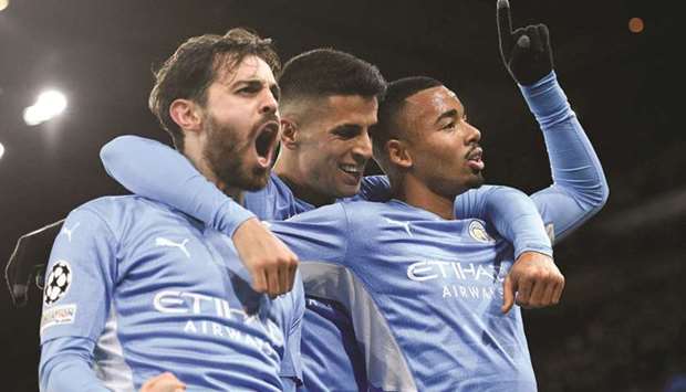 Manchester Cityu2019s Gabriel Jesus (right) celebrates with Bernardo Silva (left) and Joao Cancelo after scoring against PSG in the Champions League Group A match. (AFP)