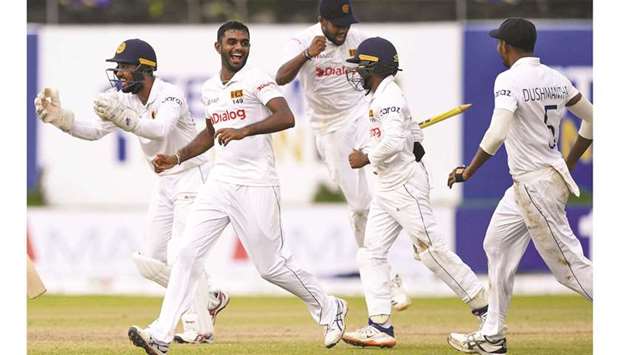 Sri Lankau2019s Lasith Embuldeniya (second from left) and teammates celebrate their victory on the fifth day of the first Test against the West Indies at the Galle International Cricket Stadium in Galle yesterday. (AFP)