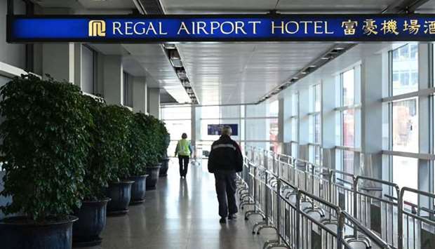 People head towards the Regal Airport Hotel at Chek Lap Kok airport in Hong Kong, where a new Covid-19 variant deemed a 'major threat' was detected in a traveller from South Africa and who has since passed it on to a local man whilst in quarantine.