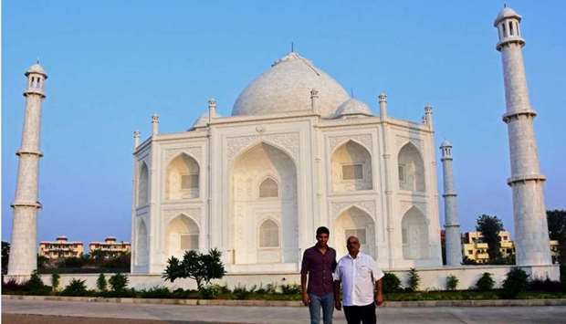 Indian businessman Anand Prakash Chouksey (R) and his son Kabir pose in front of a replica of the Taj Mahal at Burhanpur in India's Madhya Pradesh state. AFP