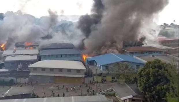 Smoke rises from burning buildings in Chinatown of Solomon Islands' capital Honiara, Solomon Islands, in this picture obtained from a social media video. @Zfm Radio My Favourite Music Station via REUTERS