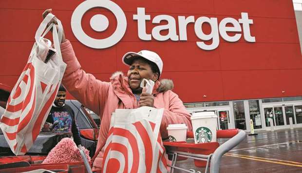 Shoppers exit Best Buy and Target stores during Black Friday sales in Brooklyn, New York.