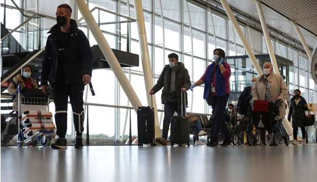 People walk inside Schiphol Airport after Dutch health authorities said that 61 people who arrived in Amsterdam on flights from South Africa tested positive for Covid-19, in Amsterdam, Netherlands. REUTERS