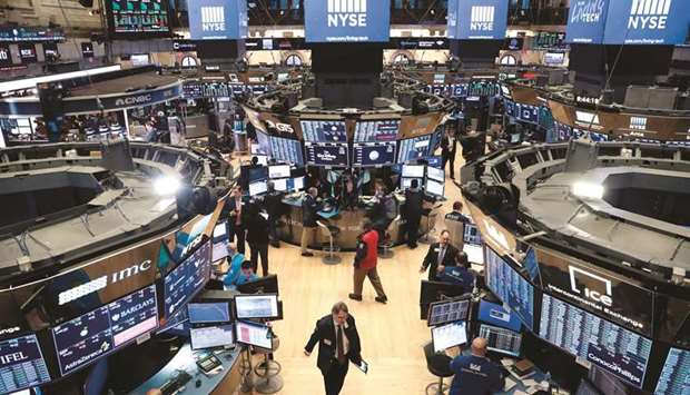 Traders work on the floor of the New York Stock Exchange (file). Covid-19 has resurfaced as a worry for investors and a potential driver of big market moves after a new variant triggered alarm, long after the threat had receded in Wall Streetu2019s eyes.