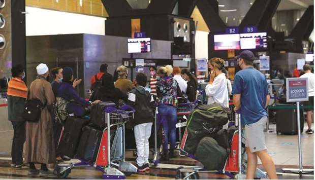 Travellers queue at a check-in counter at OR Tambo International Airport in Johannesburg, yesterday, after several countries banned flights from South Africa following the discovery of a new Covid-19 variant Omicron.