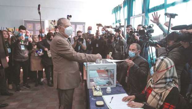 Algeriau2019s Council of the Nation (Senate) leader Salah Goudjil casts his vote during municipal and provincial council elections, at a polling station in the capital Algiers, yesterday.