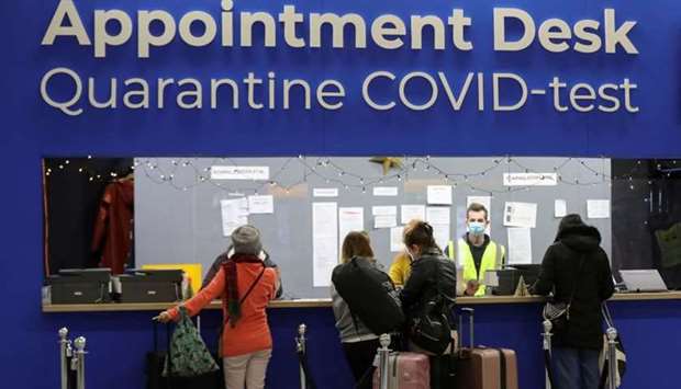 People wait in front of an ,Appointment Desk, for quarantine and coronavirus disease test appointments inside Schiphol Airport, after Dutch health authorities said that 61 people who arrived in Amsterdam on flights from South Africa tested positive for Covid-19, in Amsterdam, Netherlands, yesterday. REUTERS