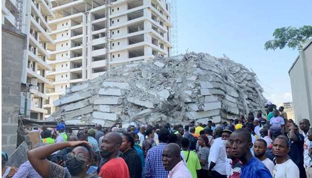 People gather at the site of a collapsed 21-story building in Ikoyi, Lagos, Nigeria. REUTERS