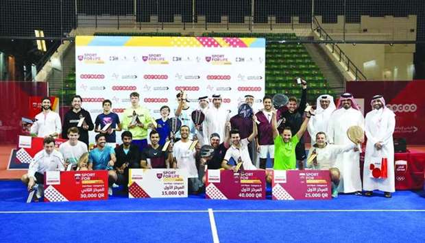Winners of the QOC Padel Tournament by Ooredoo pose with the officials