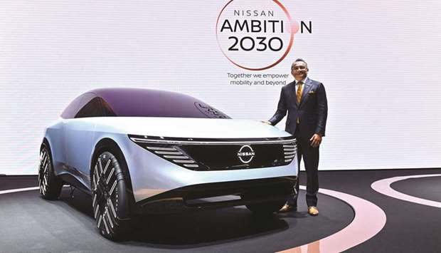 Nissan Motoru2019s chief operating officer Ashwani Gupta poses with the companyu2019s electric vehicle concept car at the companyu2019s global headquarters in Yokohama. Nissan yesterday unveiled plans for electric and hybrid vehicles to make up half its global sales by 2030, with a top executive insisting the firmu2019s u201cpioneeru201d status would help it capture market share.