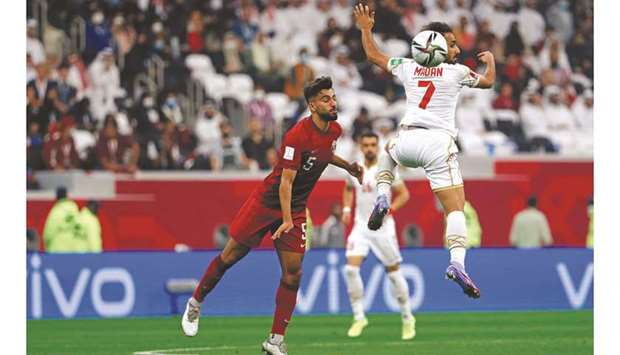 Qataru2019s Tarek Salman (left) vies for the ball with Bahrainu2019s Ali Madan during the FIFA Arab Cup 2021 Group A match at the Al Bayt Stadium in Al Khor on Tuesday. (AFP)