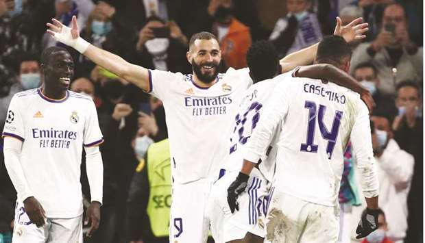 Real Madridu2019s Karim Benzema (centre) celebrates after scoring against Shakhtar Donetsk in Madrid yesterday. (Reuters)