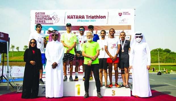 Winners of Katara Triathlon 2021 pose on the podium with the officials.