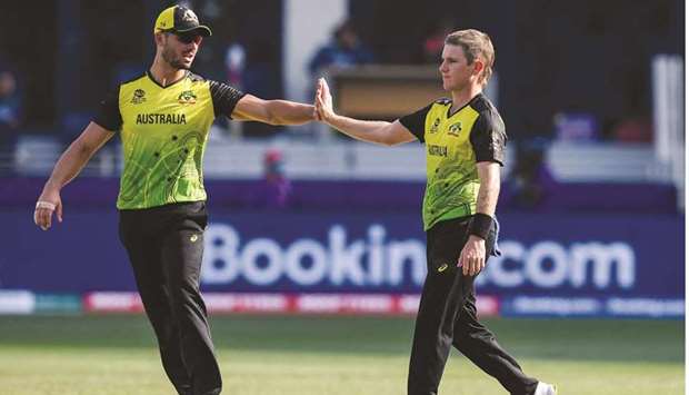 Australiau2019s Adam Zampa (right) celebrates with teammate Marcus Stoinis after dismissing Bangladeshu2019s Mustafizur Rahman (not pictured) during the ICC Twenty20 World Cup match in Dubai yesterday. (AFP)