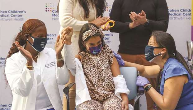 Desiree Mohamedi celebrates after receiving the Pfizer-BioNTech Covid-19 vaccine at Cohen Childrenu2019s Medical Center as vaccines were approved for children aged 5-11, amid the coronavirus disease pandemic, in New Hyde Park, New York, yesterday.