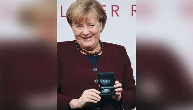 German Chancellor Merkel poses with the Walther-Rathenau Award, in Berlin, Germany.