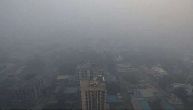 Residential buildings are seen shrouded in smog in Noida, India.