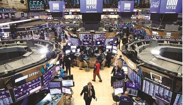 Traders work on the floor of the New York Stock Exchange (file). Rising valuations and hefty year-to-date gains for big technology stocks are pushing some investors to diversify away from the sector that has led markets for years.