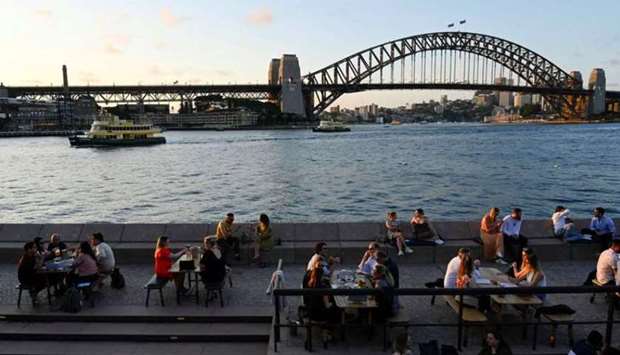 Patrons dine-in at a bar by the harbour in the wake of coronavirus disease (Covid-19) regulations easing, following an extended lockdown to curb an outbreak, in Sydney.